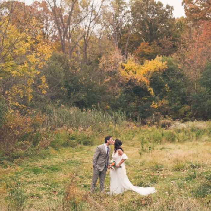 wedding photo of a couple kissing outdoors