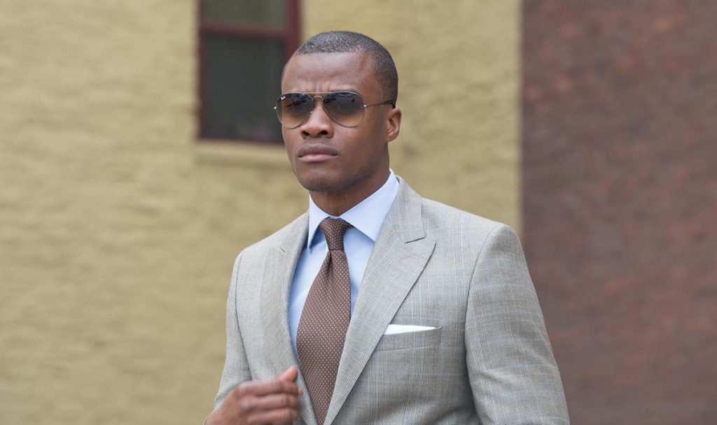 Man in peak lapel suit with tightly cropped hairstyle